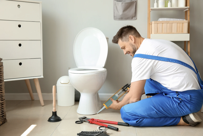 plumber fixing toilet